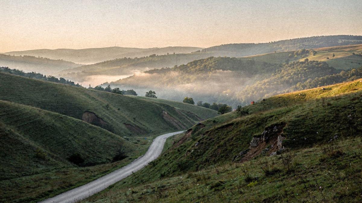 Mountain ridge and valley road in the Carpathian foothills of western Ukraine at first light